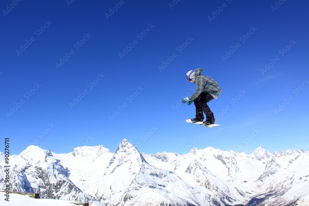 Flying snowboarder on mountains