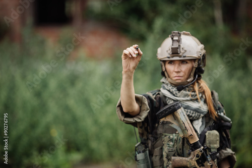 woman soldier writes marker on transparent glass