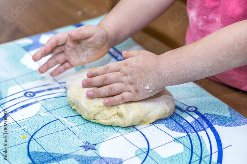 Close up of child hands making dough
