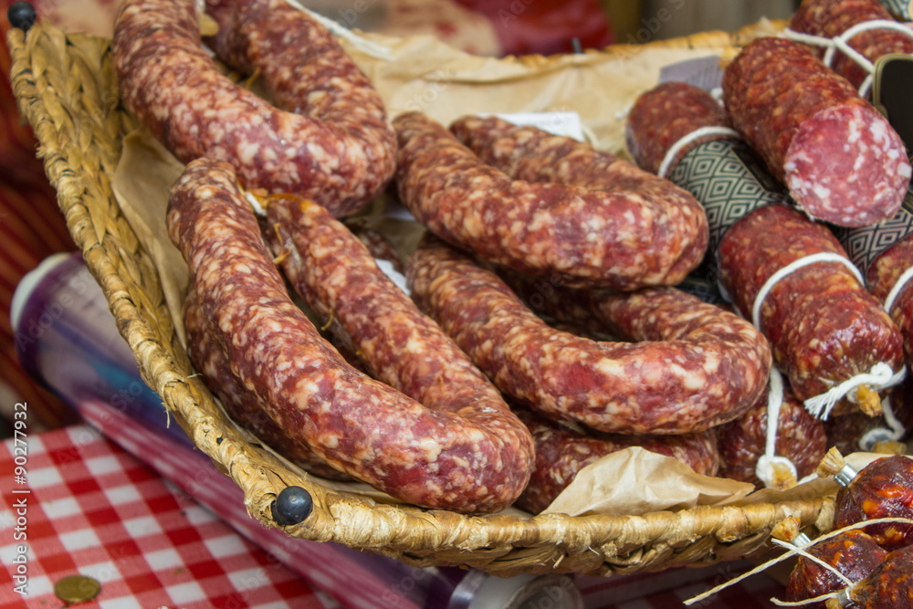 Freshly prepared raw sausage in basket on stall Freshly prepared raw sausage in basket on stall