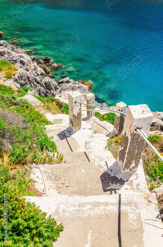 Stairs to the beach with green bushes  Greece