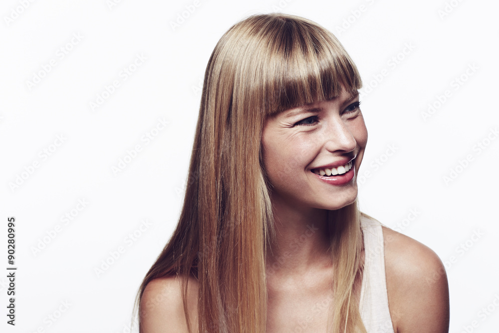 Naklejka premium Happy and smiling young blond woman in studio