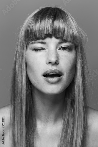 Flirting beautiful woman winking in black and white