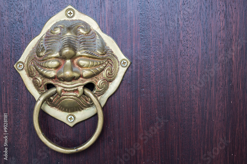 Old Chinese style door handle on the dark wood background