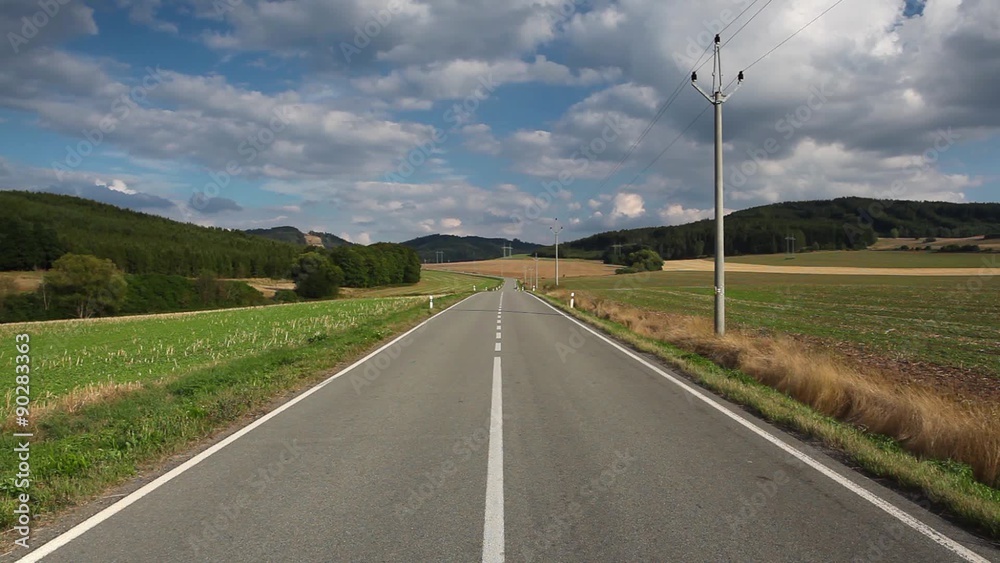 On the empty road between field