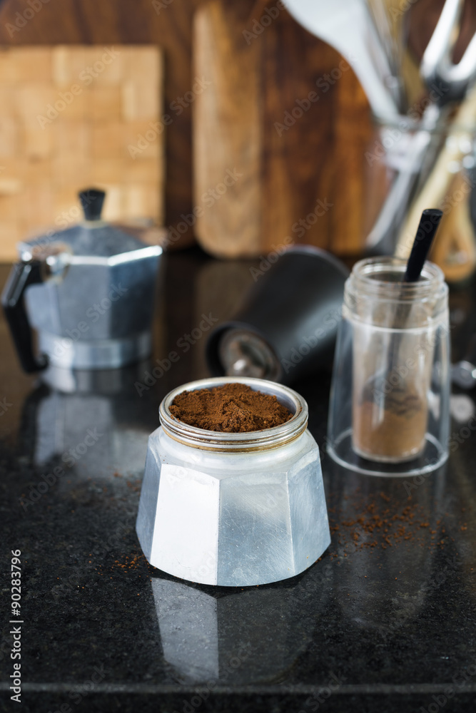 Traditional italian moka coffee pot filled with fresh ground coffee. Selective focus. Traditional italian moka coffee pot filled with fresh ground coffee. Selective focus.