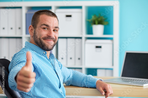 Photography Businessman working on laptop and making the ok gesture