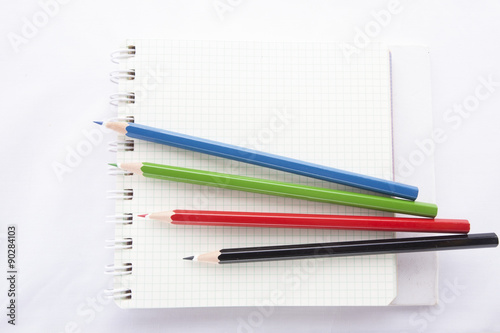 Color pencils and the ring binder book isolated on white background