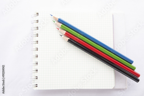 Color pencils and the ring binder book isolated on white background
