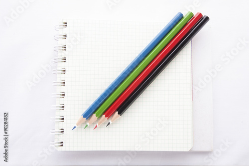 Color pencils and the ring binder book isolated on white background