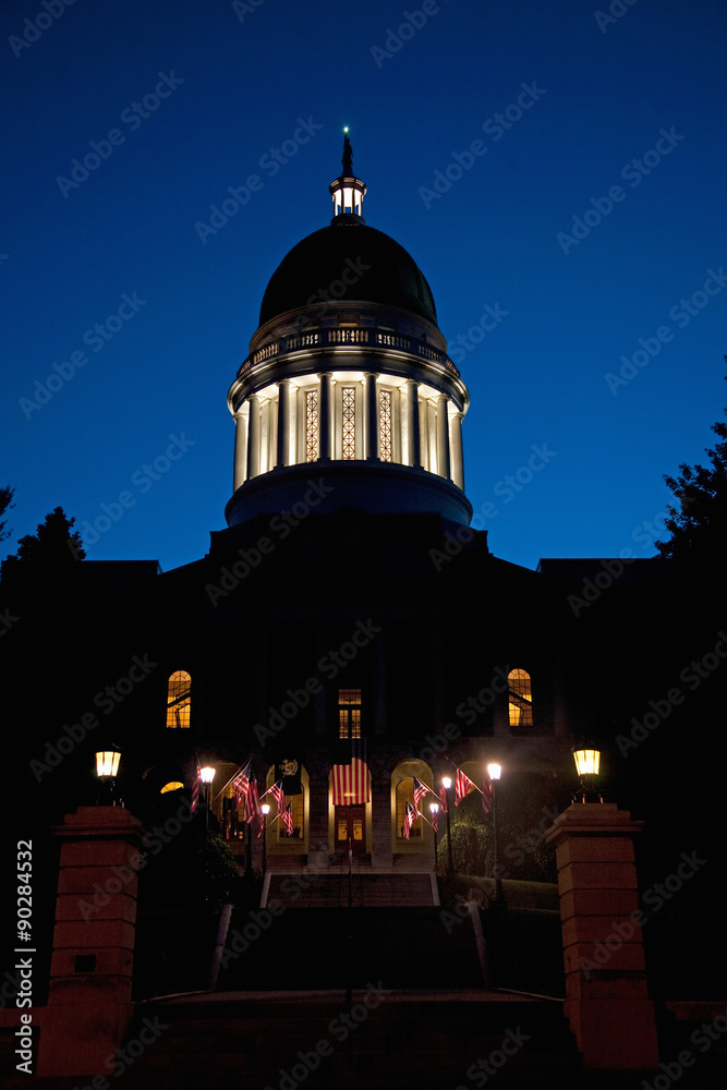 Historic Maine State Capitol Building at dusk with deep blue sky, Augusta, Maine, the state capital.