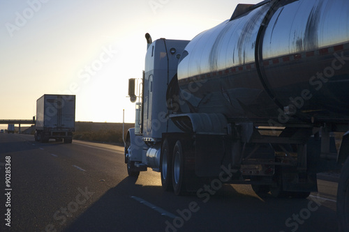 Fuel truck into setting sun on Interstate 15 in California.