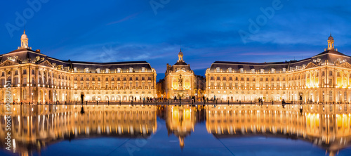 Panoramic view of Place la Bourse in Bordeaux, reflections in the water mirror illuminated at night, France