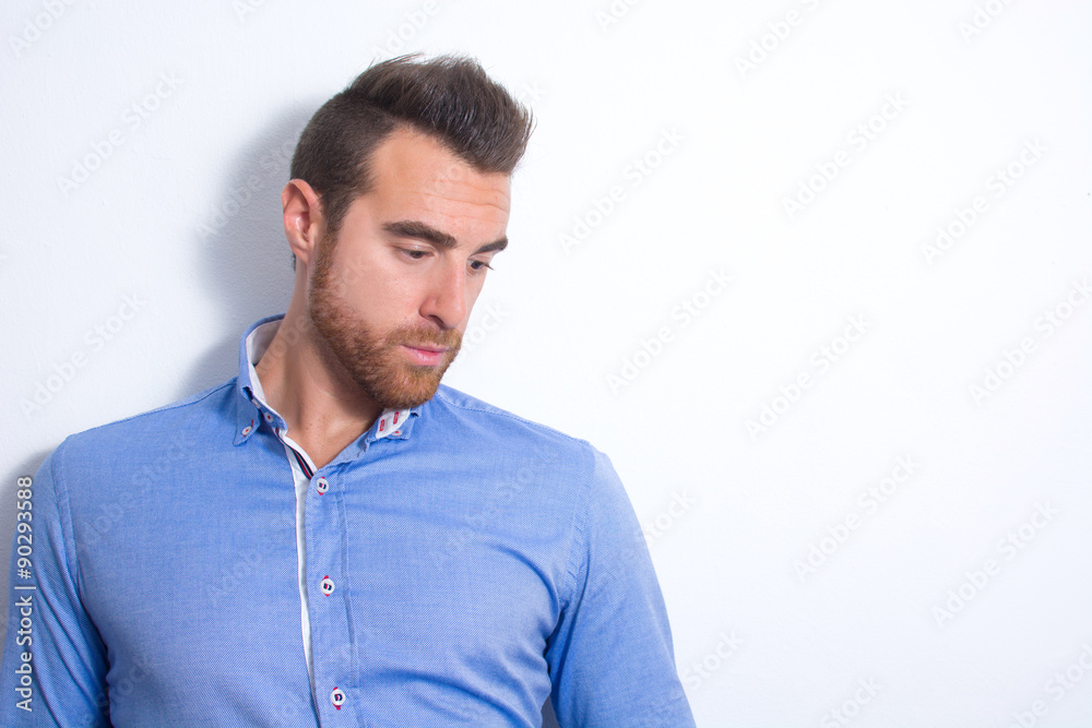 Young man posing as a model. Shadow in the wall Young man posing as a model. Shadow in the wall