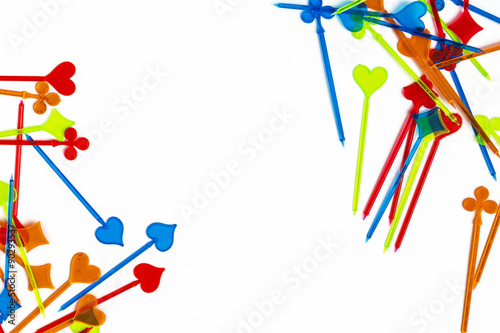Colorful plastic cocktail sticks on white background