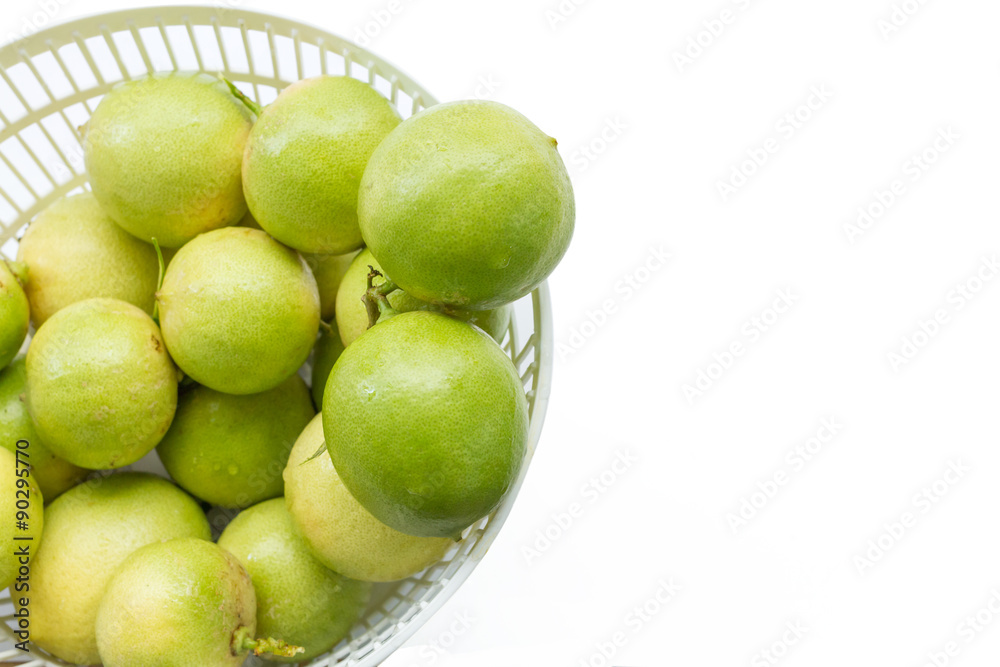 fresh limes in plastic basket on white fresh limes in plastic basket on white