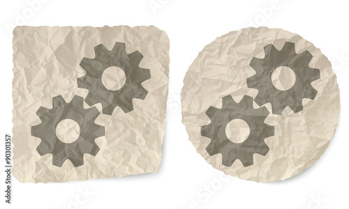 Crumpled slip of paper and a cogwheels