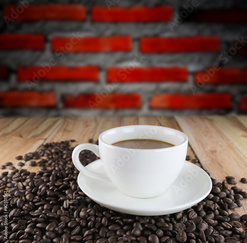 White coffee cup and roasted coffee beans.