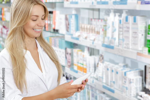 Beautiful pharmacist choosing the product in drugstore Free Download Beautiful pharmacist choosing the product in drugstore - GFXLoad