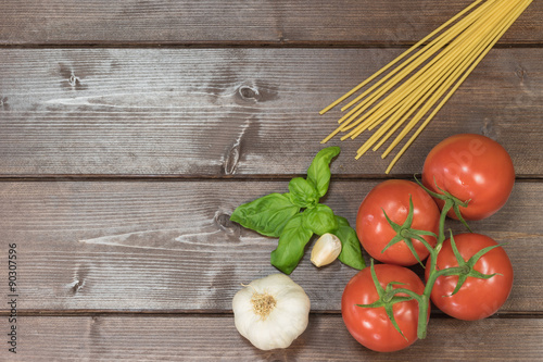 Tomatoes, garlic, basil leaves and spaghetti