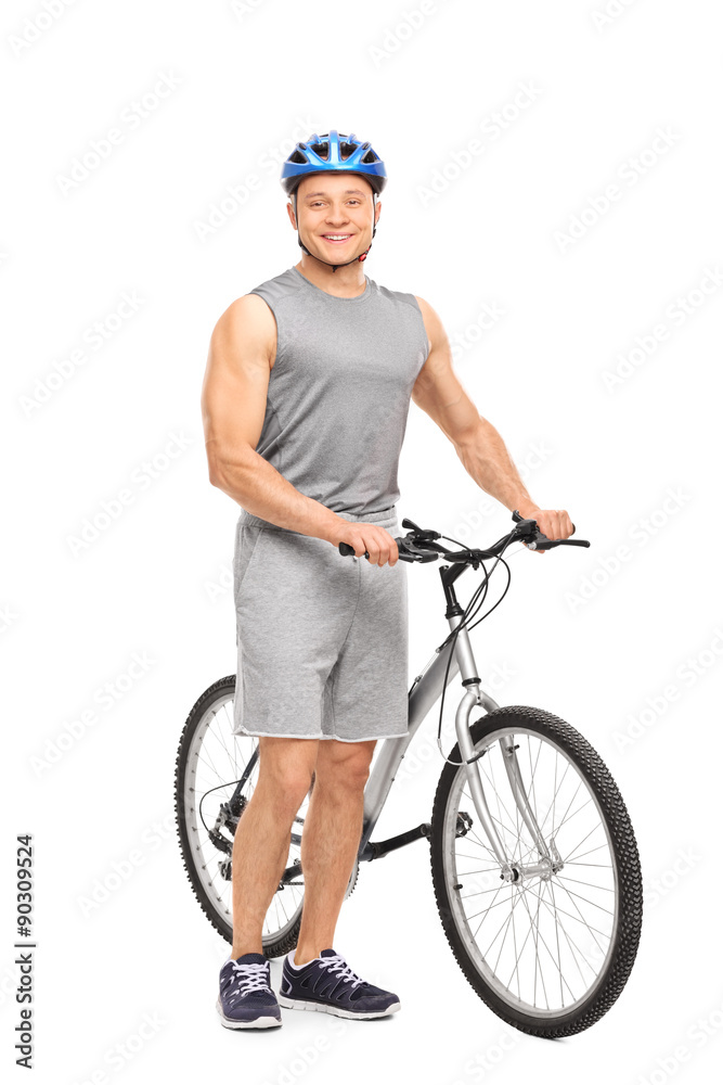 Naklejka premium Young man posing next to his bicycle and smiling