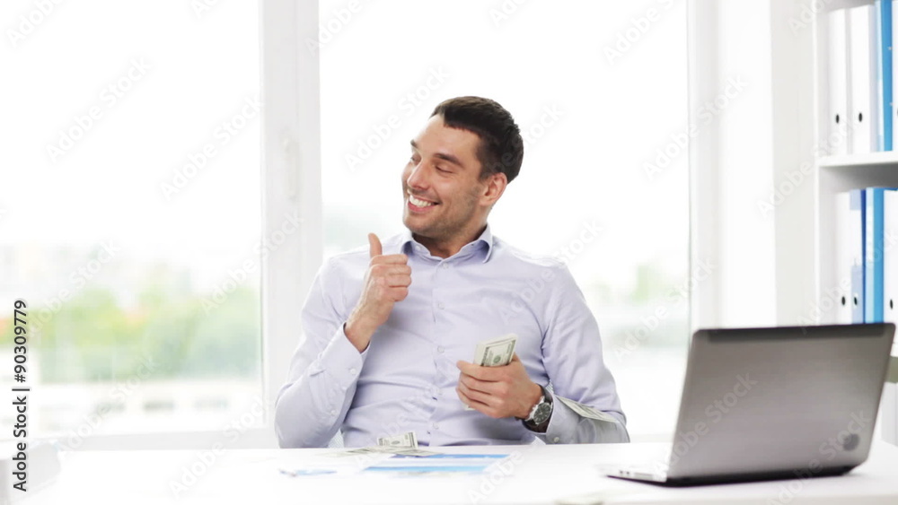 happy businessman with money and laptop in office happy businessman with money and laptop in office