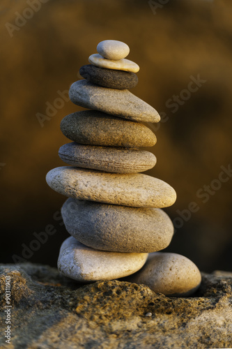 Stack of balanced pebbles  stones against colorful rock