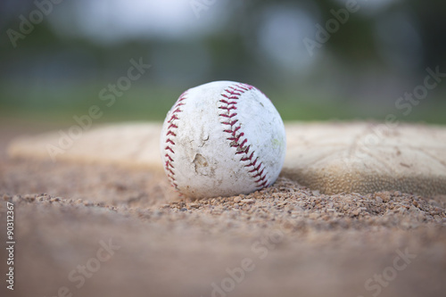 Selective focus low angle of grungy baseball and base