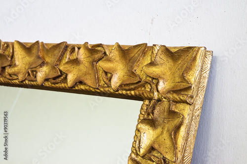 Detail of a carved and golden wooden frame photo