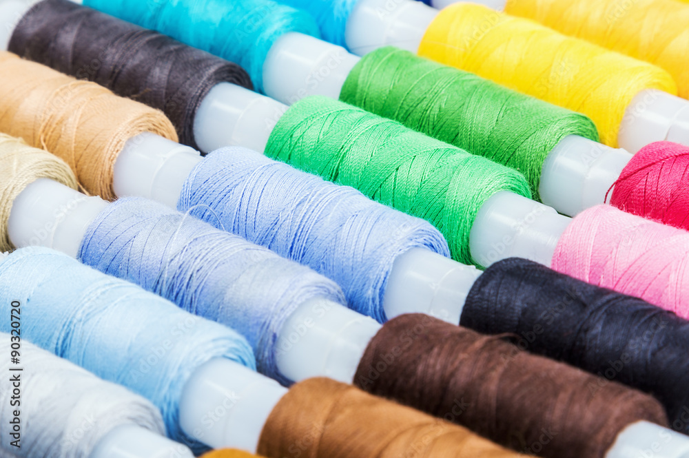 Multicolor sewing threads on background Multicolor sewing threads on background