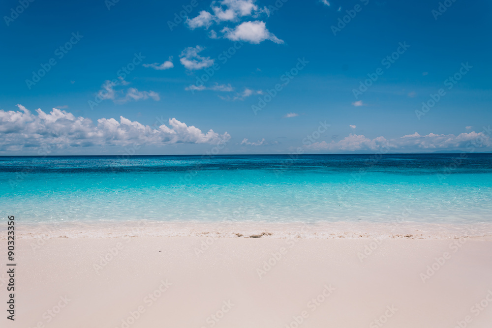 blue sky with sea and beach - soft focus with film filter