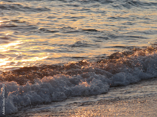 Close-up of ocean sea waves in the warm sunset light