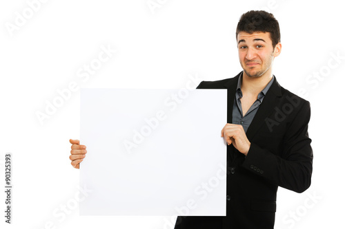 Young businessman holding blank board