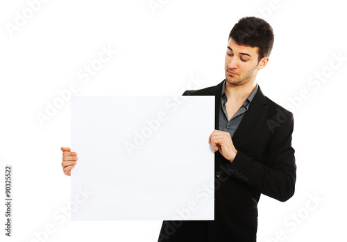 Young businessman holding blank board