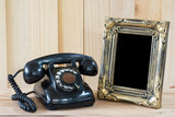 Old telephone and empty picture frame.