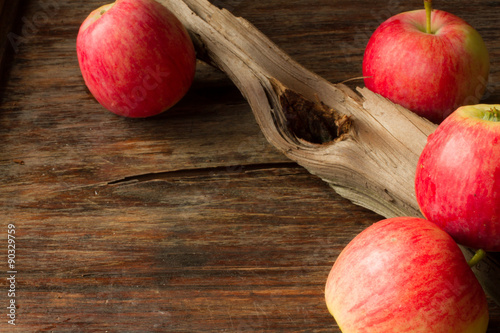 ripe red apples on a wooden background