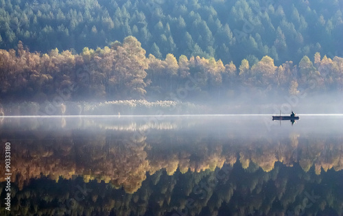 Tela One angler fishing on a misty lake.