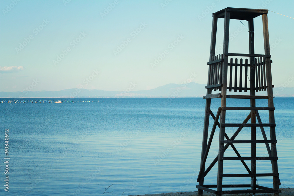 Resro, rustyc, old, wooden Safeguard's tower on the beach against blue sea, ocean. Idyllic place for vacation. Summer holiday, postcard, background