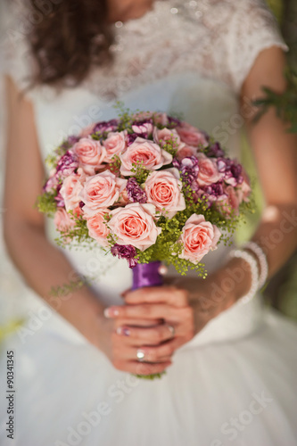 Fototapeta Naklejka Na Ścianę i Meble -  Wedding bouquet at bride's hands