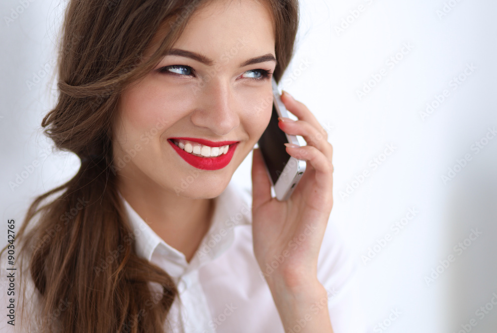 Smiling businesswoman talking on the phone at the office