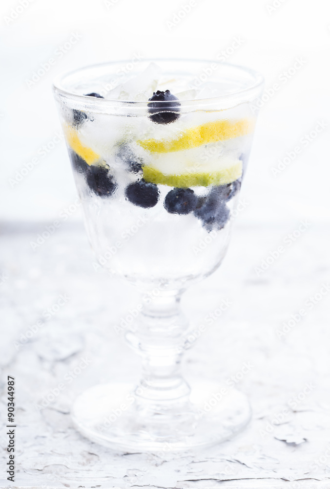 Detox water cocktail,blueberry ,lime, lemon and ice.selective focus Detox water cocktail,blueberry ,lime, lemon and ice.selective focus