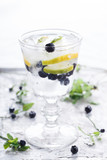 Detox water cocktail,blueberry ,lime, lemon and ice.selective focus