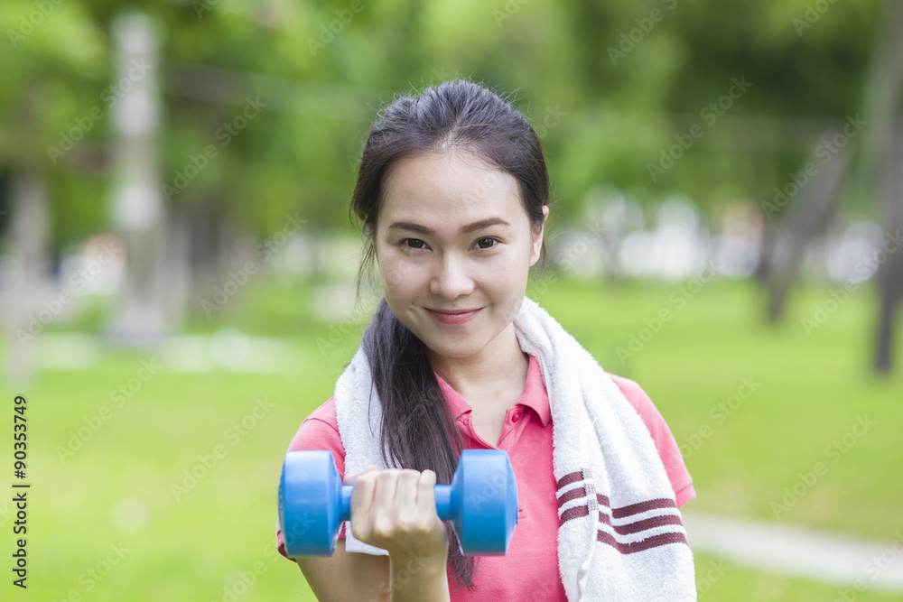 Fitness woman lifting dumbbell weight training outside Fitness woman lifting dumbbell weight training outside