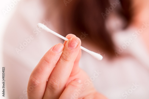 Cotton buds in woman s hand
