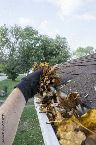 Cleaning Dry Leaves Out Of A Gutter