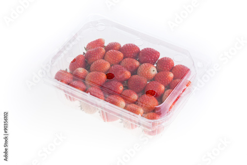 red ripe strawberry in plastic box of packaging, isolated