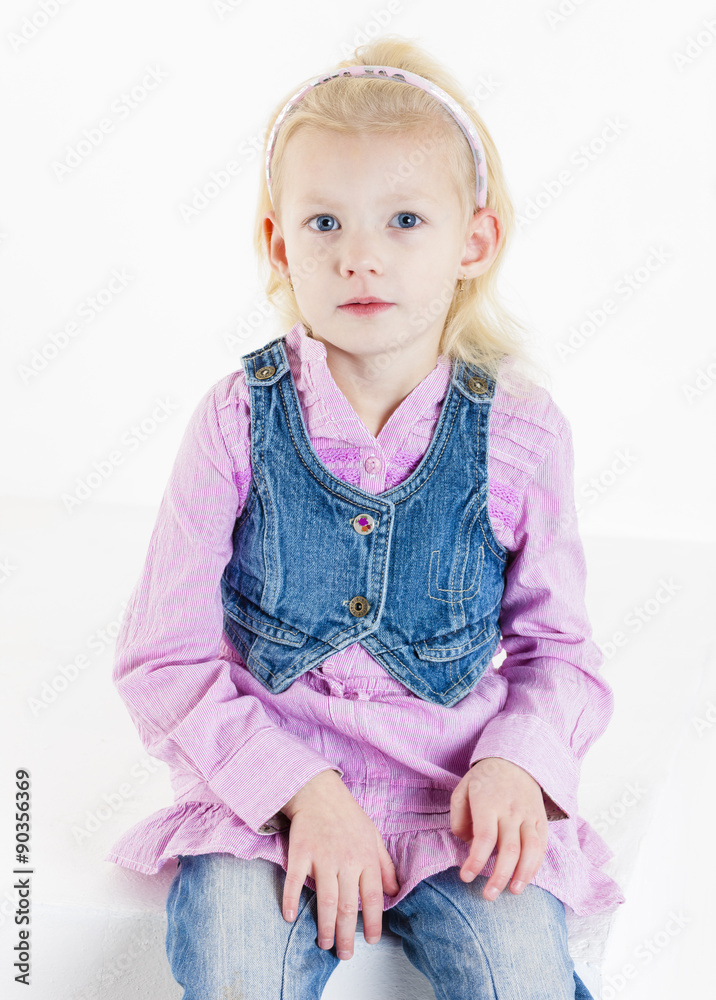 portrait of sitting little girl wearing jeans portrait of sitting little girl wearing jeans