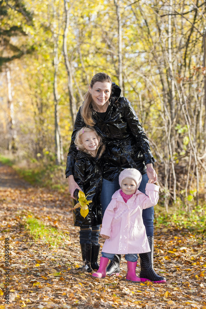 mother with her daughters in autumnal nature mother with her daughters in autumnal nature