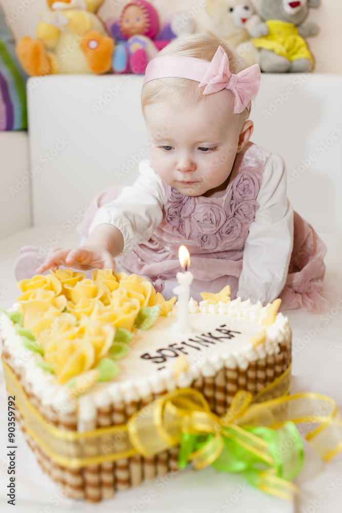 portrait of sitting toddler girl with her birthday cake portrait of sitting toddler girl with her birthday cake