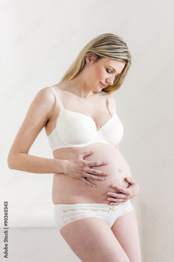 portrait of pregnant woman wearing lingerie portrait of pregnant woman wearing lingerie